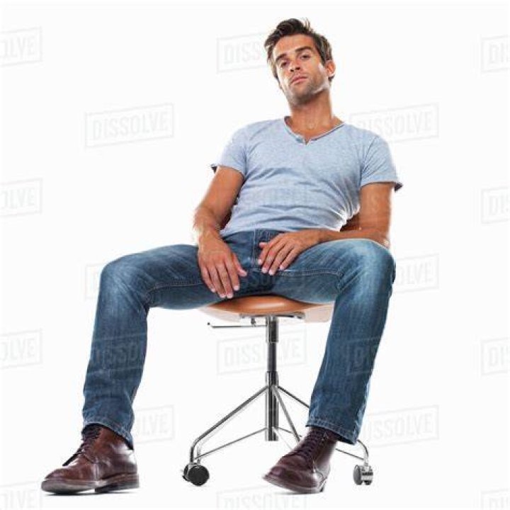 a man sitting at a table holding a wine glass