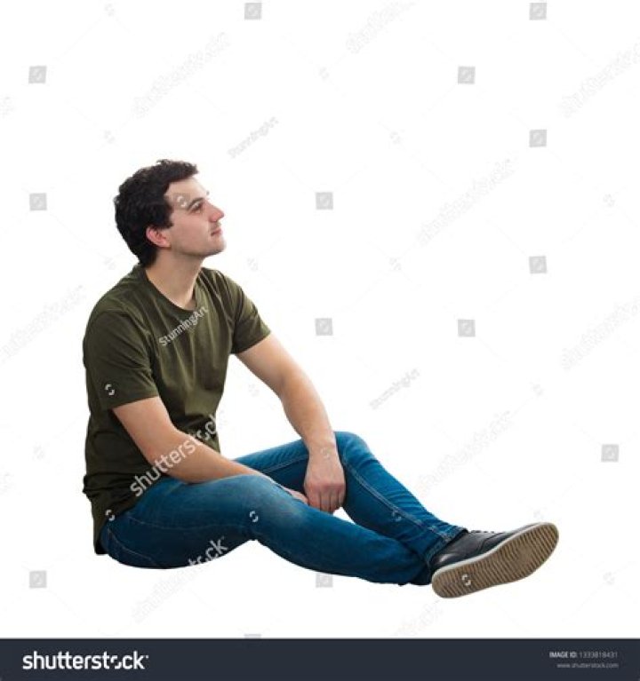 a man sitting down with his hands crossed